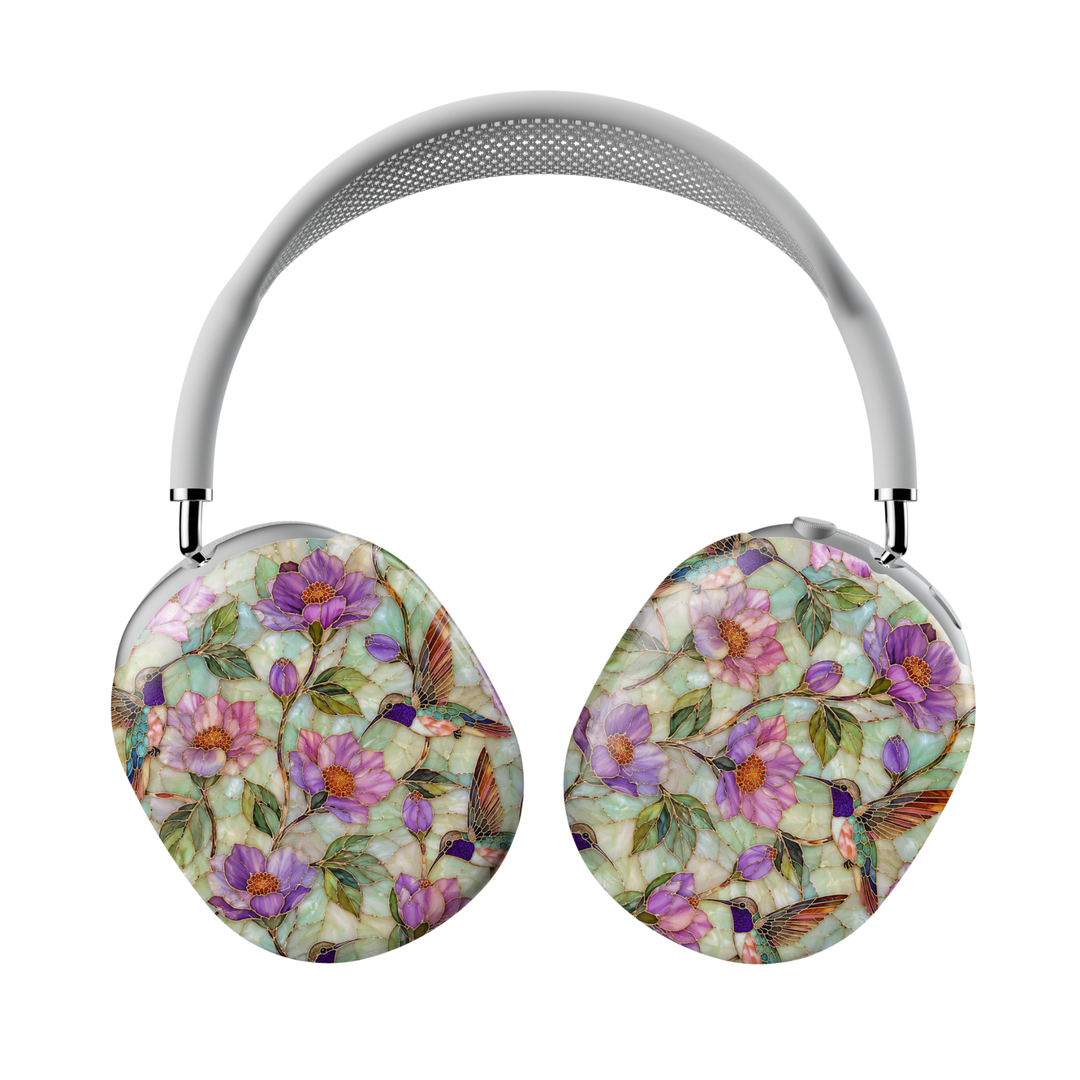 AirPods Max covers featuring colorful hummingbirds, purple flowers, green leaves, and stained-glass-inspired botanical artwork on a soft jade background.
