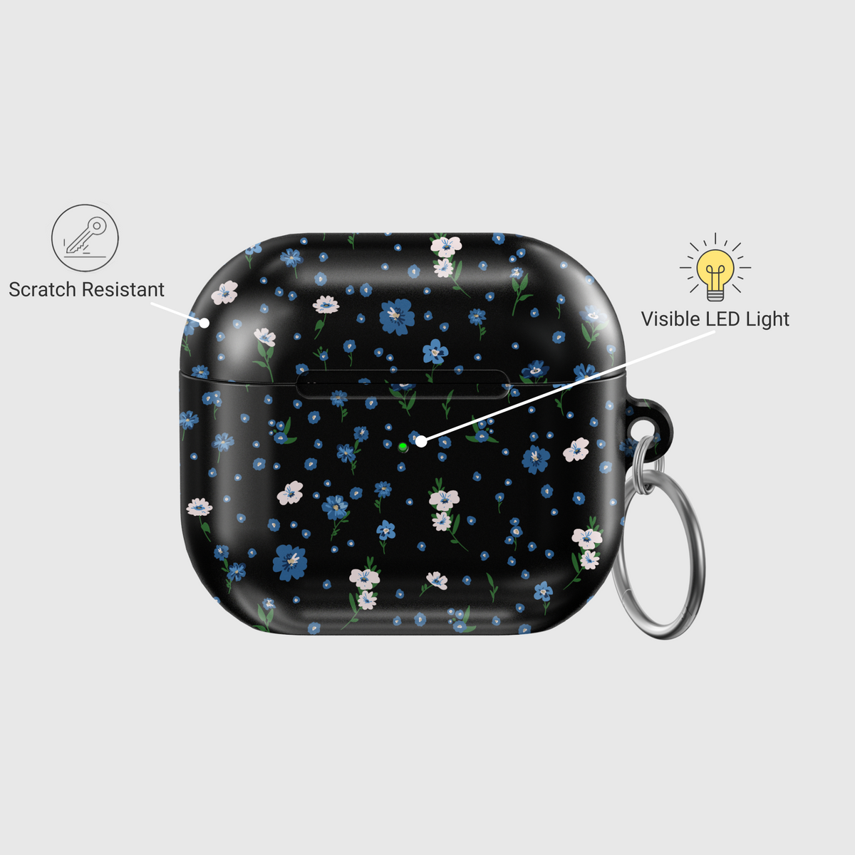 Black AirPods case with tiny blue and white floral print, silver keychain attachment, inspired by indie music vibes and soft aesthetic design for AirPods Pro or AirPods 3.