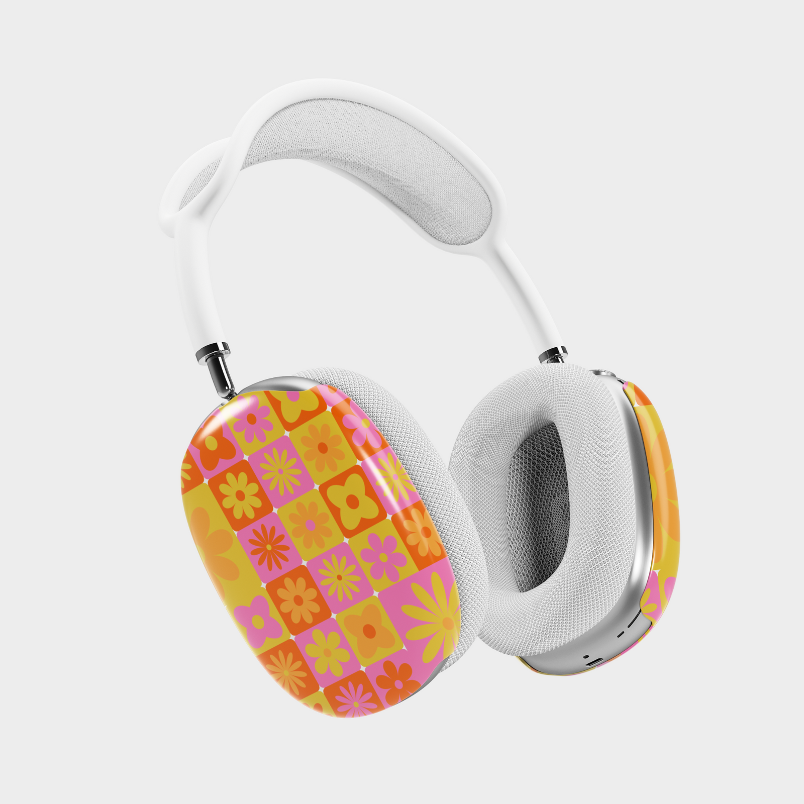 AirPods Max cover with colorful retro floral checker pattern in orange, pink, and yellow – groovy 70s-inspired design.