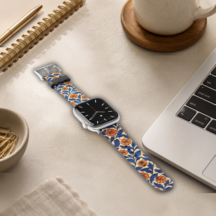 Azure Bloom floral Apple Watch band featuring cobalt blue leaves and amber orange flowers printed on premium vegan leather with soft faux-suede lining and stainless steel hardware. Compatible with Apple Watch Series 1–10, SE, Ultra, and Ultra 2.