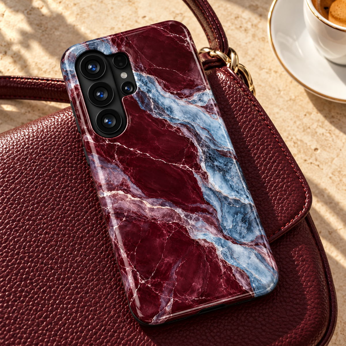Glossy CASELIX Samsung Galaxy tough case with burgundy red marble print, flowing icy blue bands and fine white veining on a white background.
