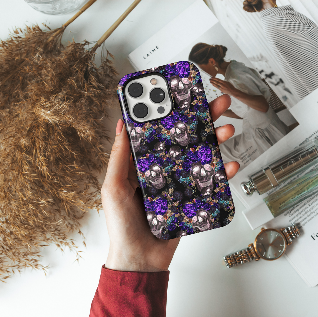 Halloween skull iPhone case with purple floral crown, black background, spooky dark roses, gothic fall theme, and eerie floral Halloween vibes.