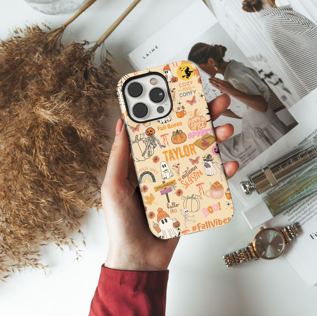 Cute Halloween iPhone case with personalized name Taylor, fall icons, ghosts, pumpkins, skeletons, spider webs, pumpkin spice, and cozy autumn sayings.