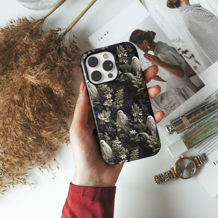Skeleton and floral iPhone case with beige skulls and cream roses hidden in purple botanical foliage, perfect for gothic Halloween or spooky aesthetic lovers.