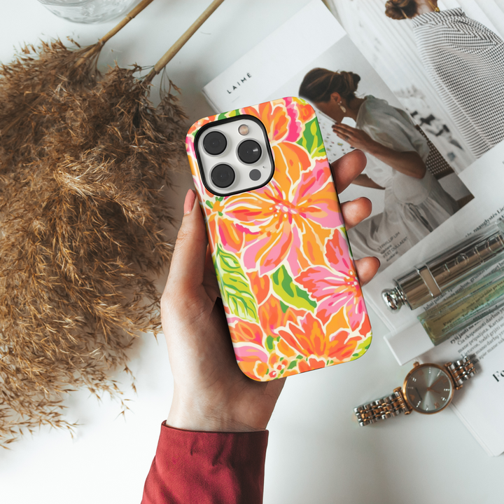 Colorful tropical floral phone case for iPhone 16 Pro Max featuring orange, pink, and green flower design with durable tough protection