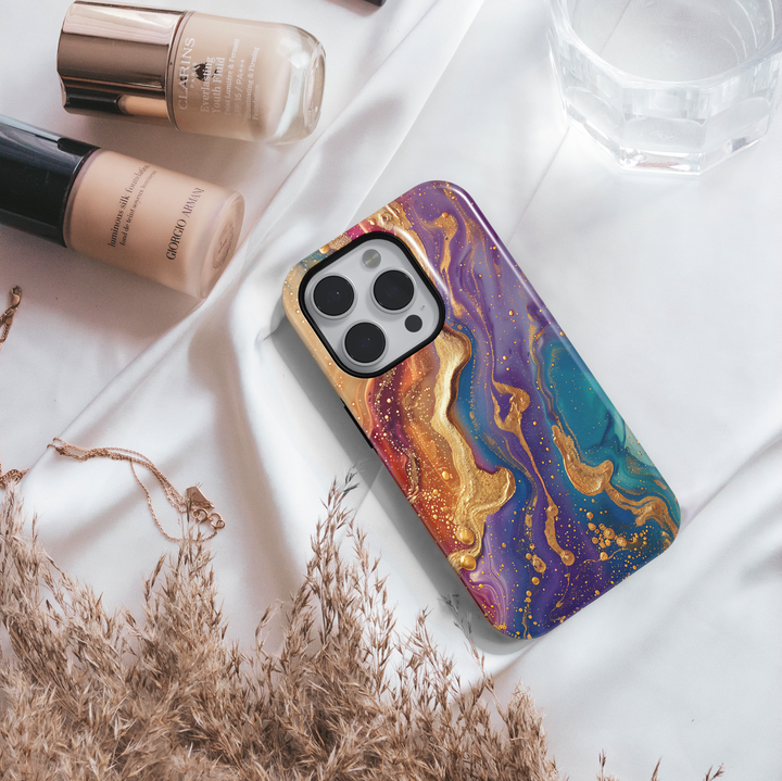 Tough iPhone 16 MagSafe case featuring vibrant purple, teal, and gold swirl design with a glossy finish.