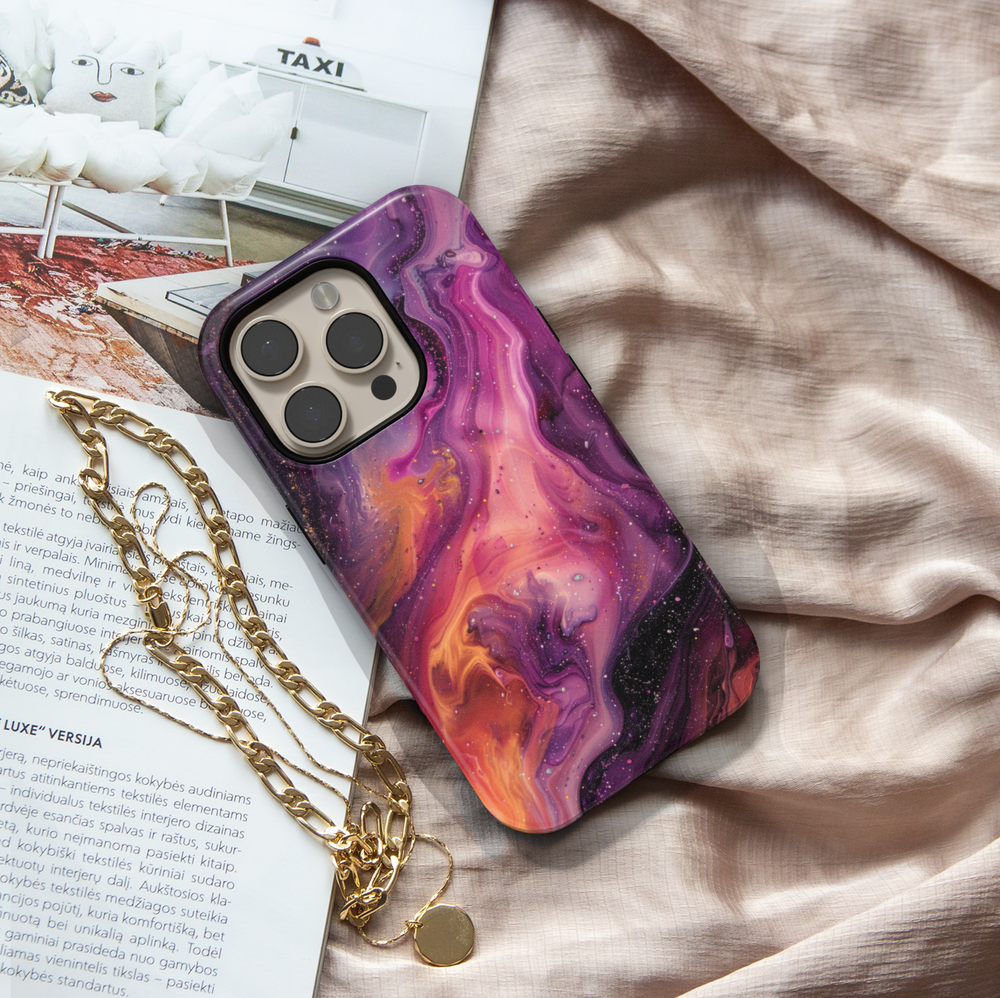 Vibrant iPhone case with a swirling abstract galaxy design in purples, oranges, and black; bold MagSafe-compatible tough case for iPhone 16.

