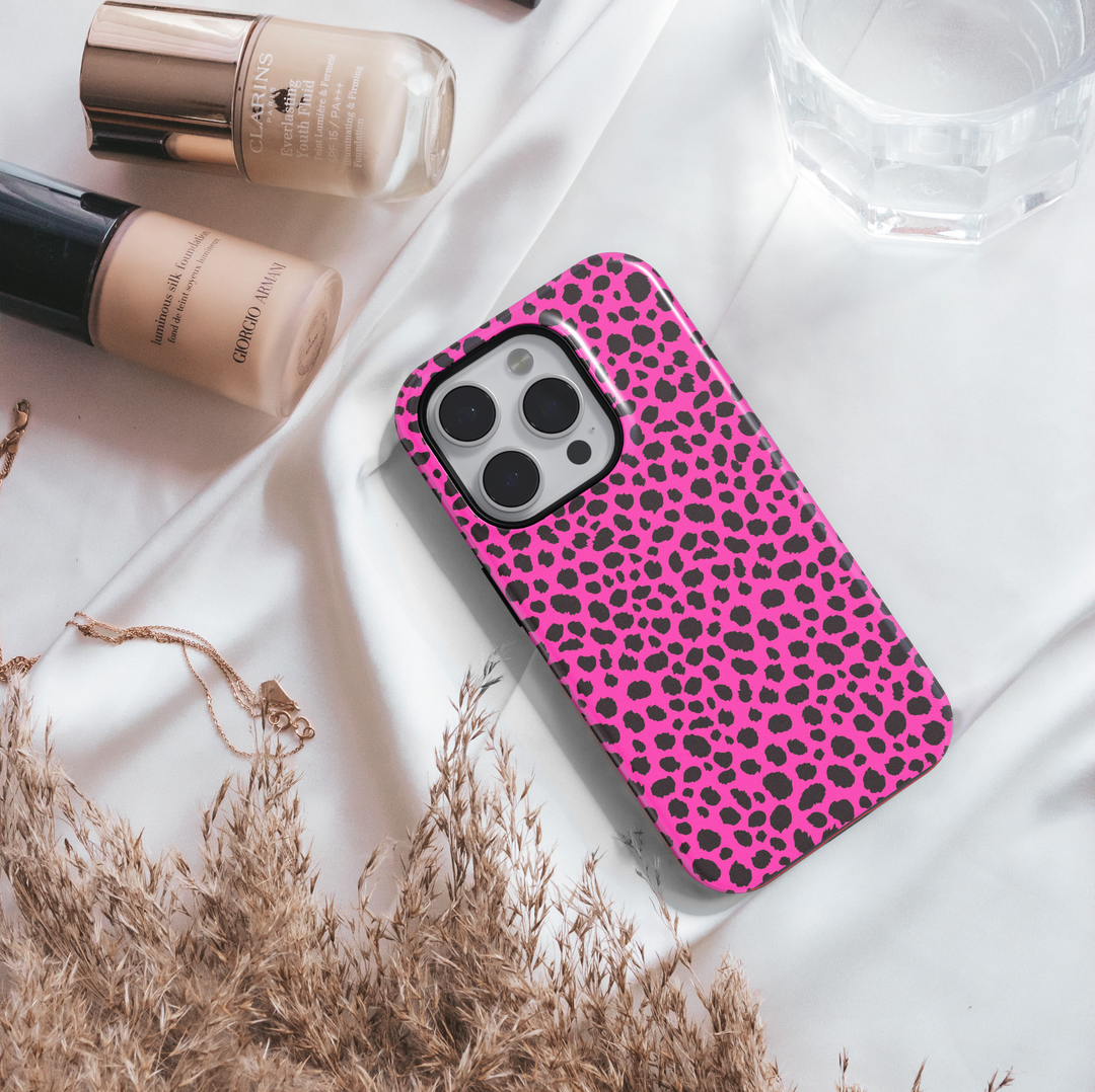 Hot pink leopard print iPhone case with bold black animal spots, designed for iPhone 16 series and MagSafe compatible, featuring a girly wild aesthetic.

