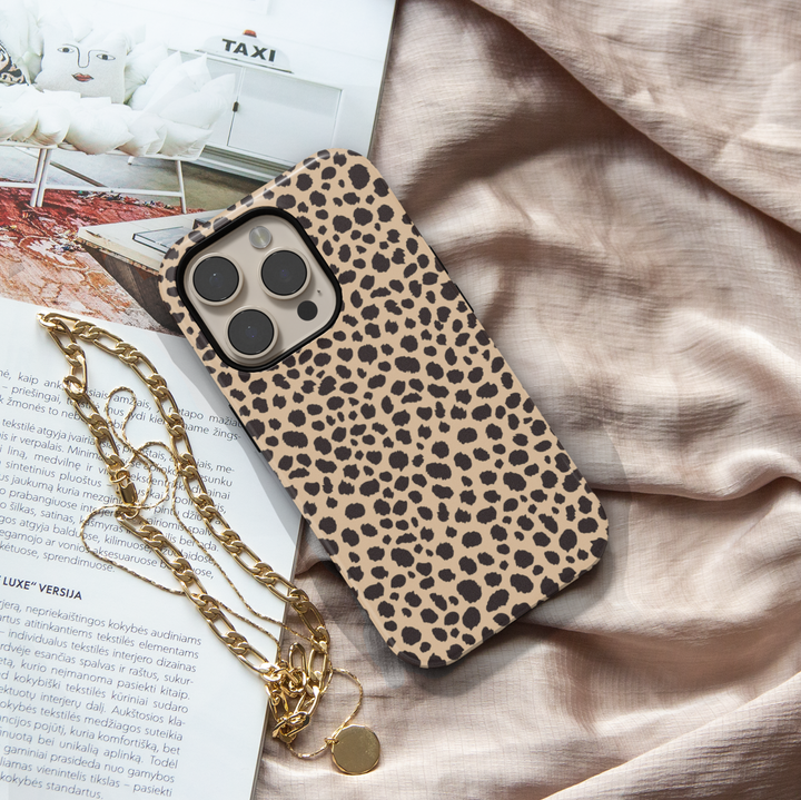 Leopard print iPhone case with bold black animal spots on a tan background, designed for iPhone 16 series with MagSafe compatibility.

