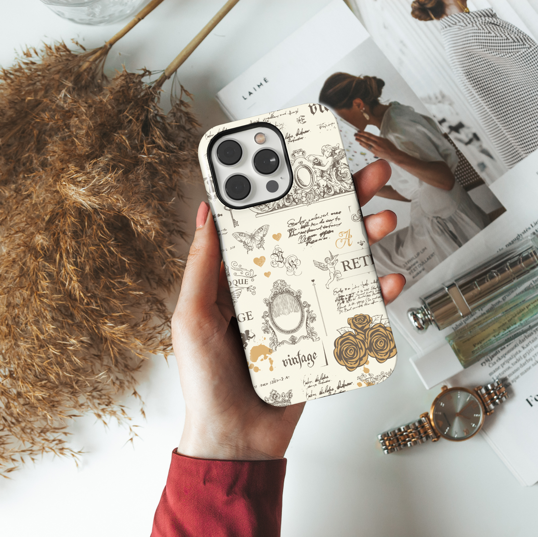 Cream vintage aesthetic iPhone case with antique sketches of cherubs, roses, ornate frames, French script, butterflies, and baroque elements.