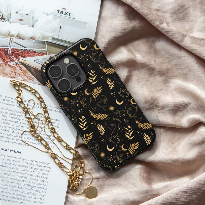 Black and gold celestial iPhone case featuring abstract face line art, crescent moons, suns, stars, and botanical leaves – modern boho astrology aesthetic, compatible with iPhone 16, iPhone 15 Pro Max, Galaxy S24 Ultra, and MagSafe.