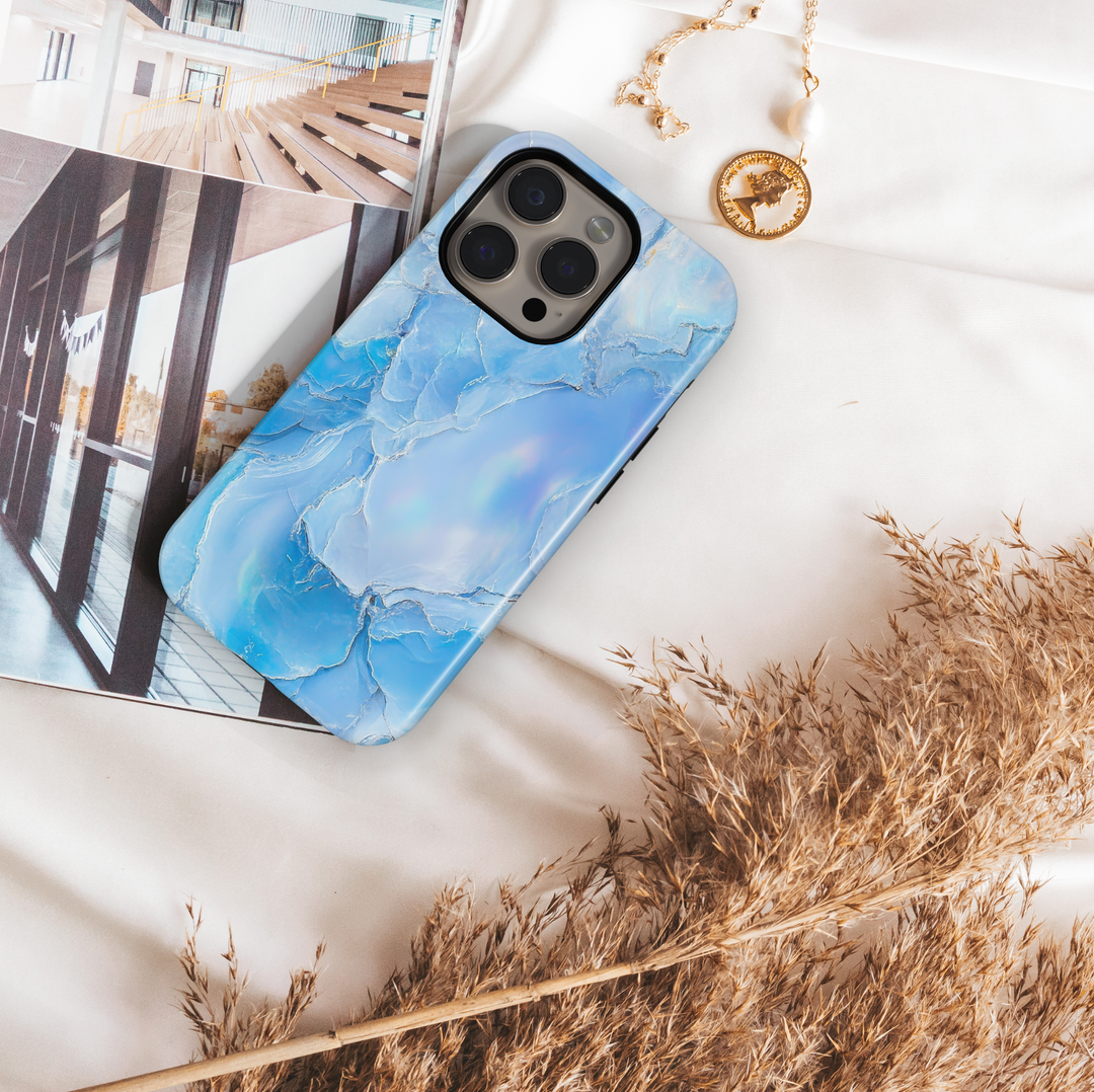 Light blue opal marble iPhone case with shimmer finish – compatible with iPhone 16 Pro, 15, 14 Plus, Galaxy S24 Ultra, and MagSafe.
