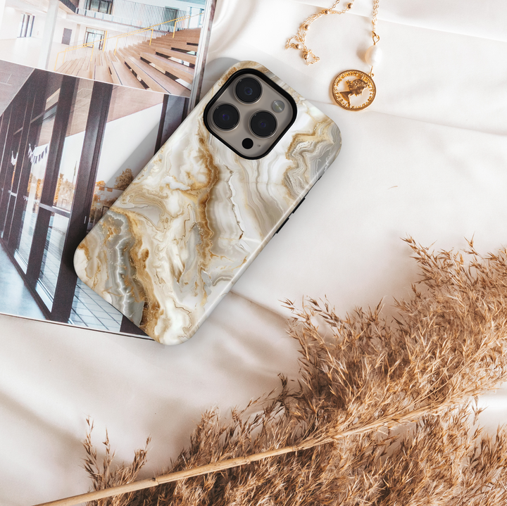 Elegant white marble iPhone case with gold vein accents – luxury stone design cover compatible with iPhone 16, 15, 14 Pro & Plus with MagSafe support.