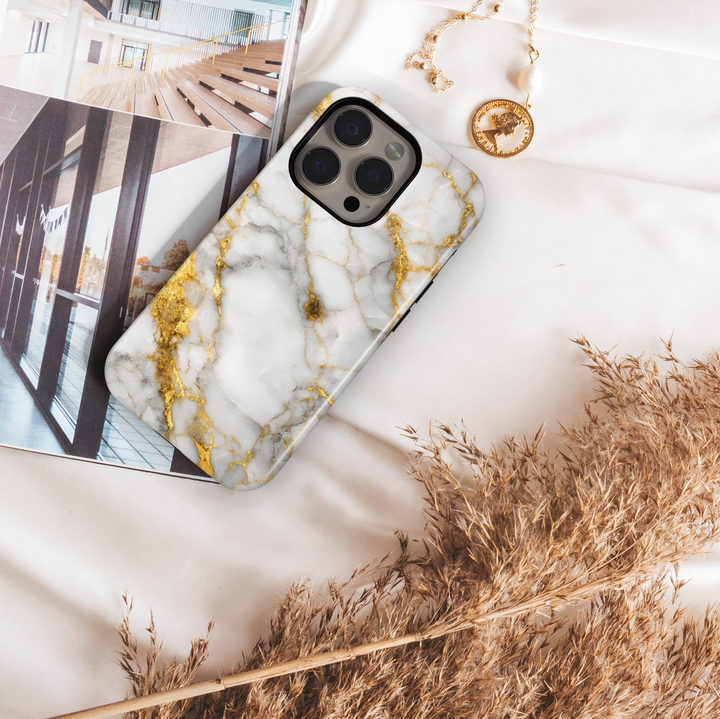 Elegant white marble iPhone case with gold vein accents – luxury stone design cover compatible with iPhone 16, 15, 14 Pro & Plus with MagSafe support.