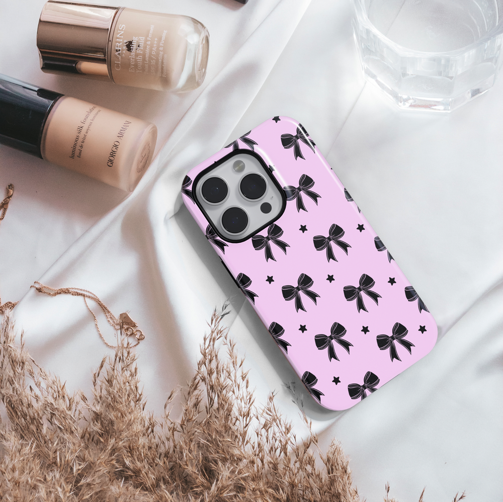 Girly pink iPhone case with black bow and star pattern – cute, aesthetic, and stylish protective phone cover for women and girls, compatible with iPhone models 14, 15, and 16.