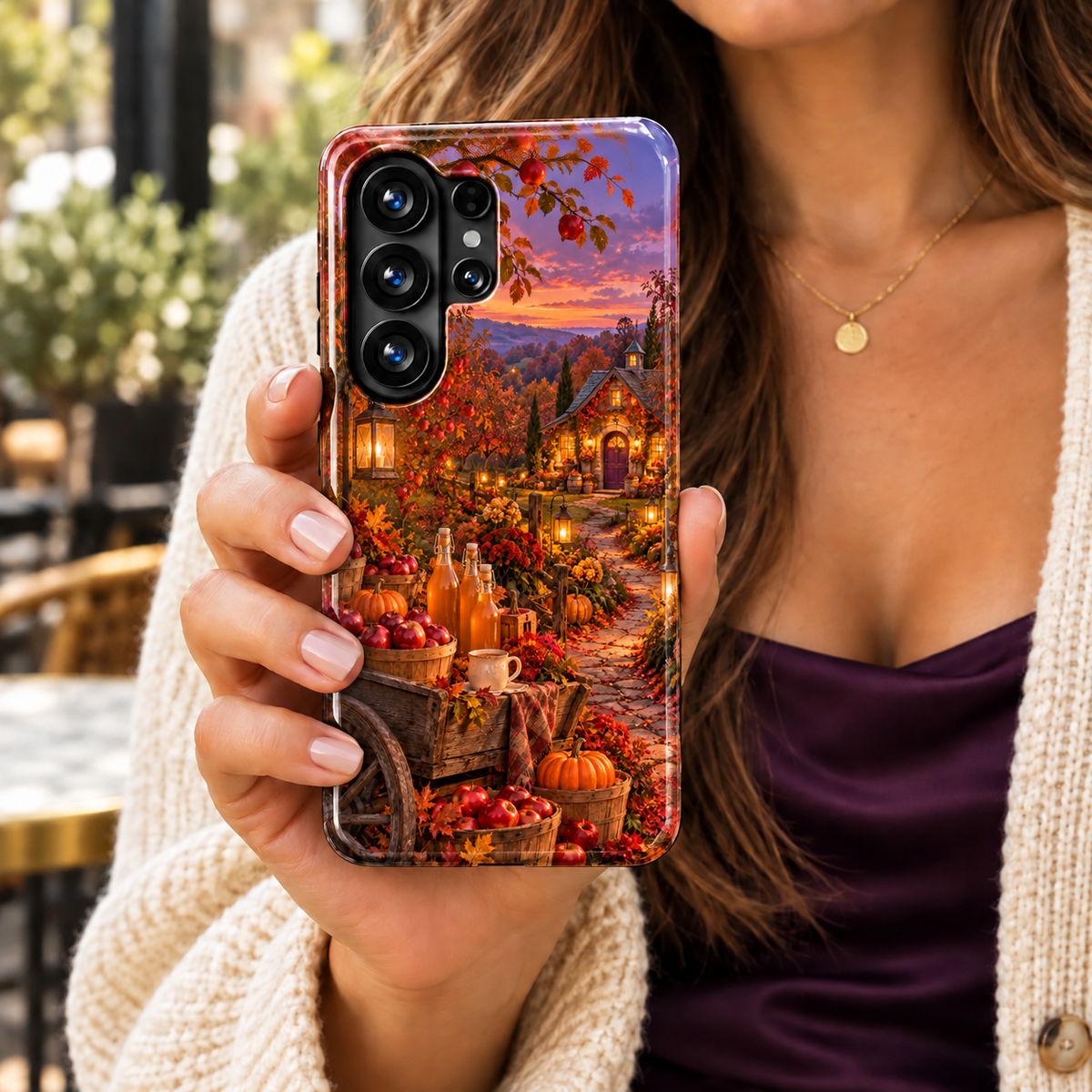 Cider & Stardust Samsung Galaxy case featuring a wooden cart with red apples, cider bottles and pumpkins beside a lantern-lit orchard cottage at dusk.