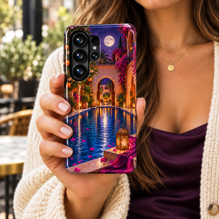 CASELIX Moonwater Riad Samsung Galaxy case featuring a moonlit Moroccan courtyard, blue reflecting pool, pink bougainvillea and glowing lantern.
