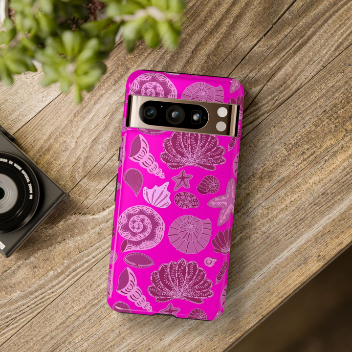 Vibrant pink seashell design phone case for Google Pixel with beachy ocean elements like starfish, shells, and coral – protective and aesthetic