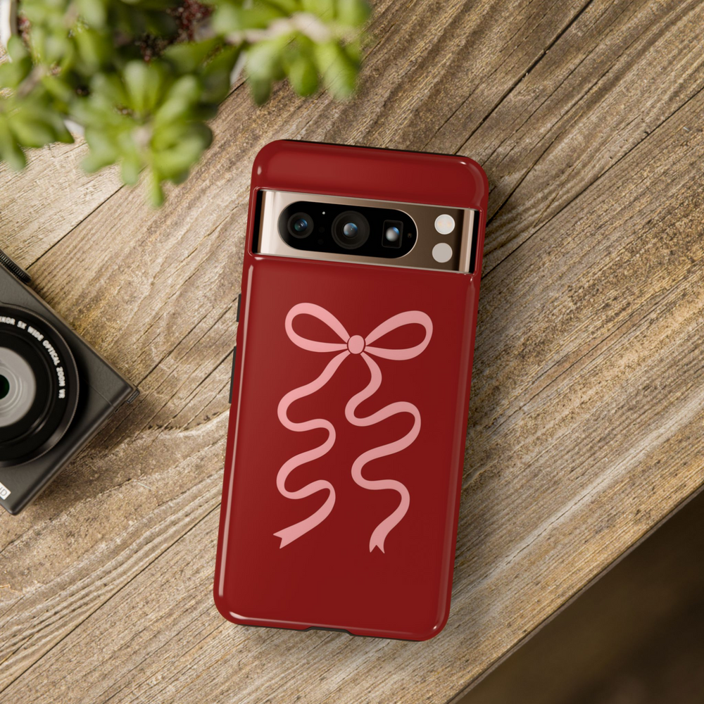 Dark red Google Pixel tough phone case with pink wavy ribbon bow – aesthetic coquette-inspired cover for Pixel 8, Pixel 8 Pro, and Pixel 9 Pro XL