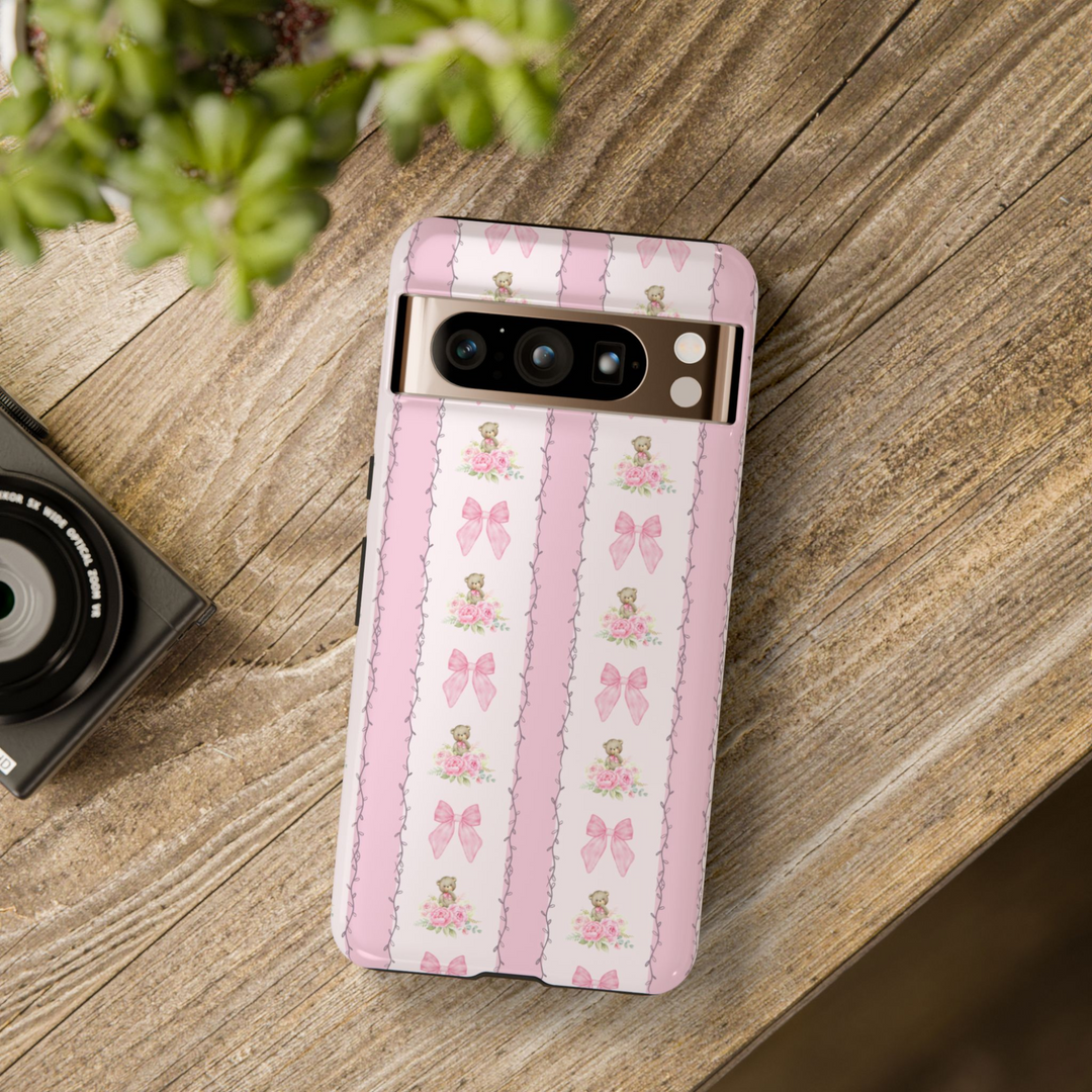 Google Pixel phone case with vertical pink stripes featuring teddy bears, pink bows, and floral bouquets in a vintage girly pattern

