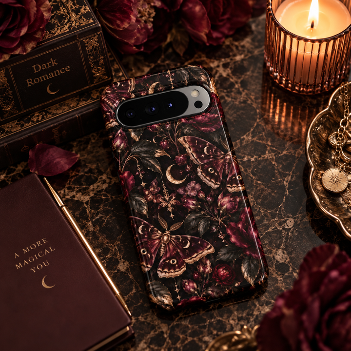 Midnight Moth Garden Google Pixel case featuring burgundy moths, crescent moons, deep wine flowers, dark botanical leaves and antique gold celestial details on a black background.