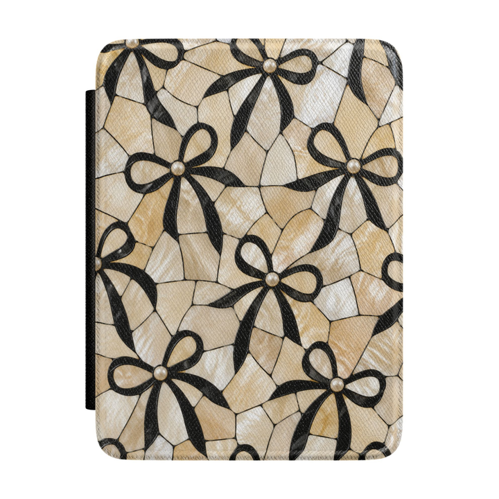 Elegant Kindle case featuring black ribbon bows, pearl accents, and an ivory mosaic-inspired background in a chic coquette aesthetic design.