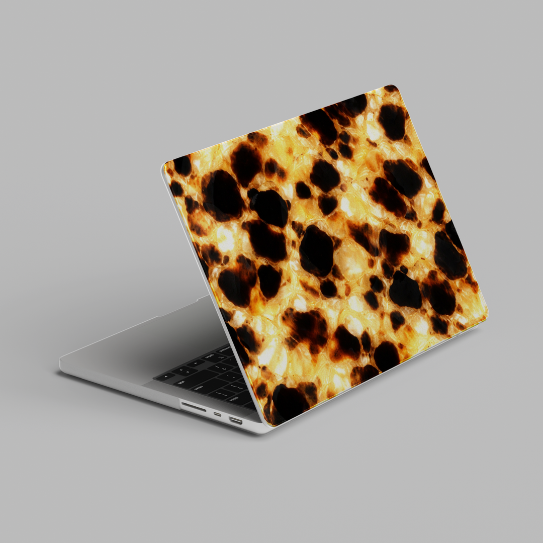 Golden leopard tortoiseshell MacBook case with warm amber and black animal print on slim protective laptop cover