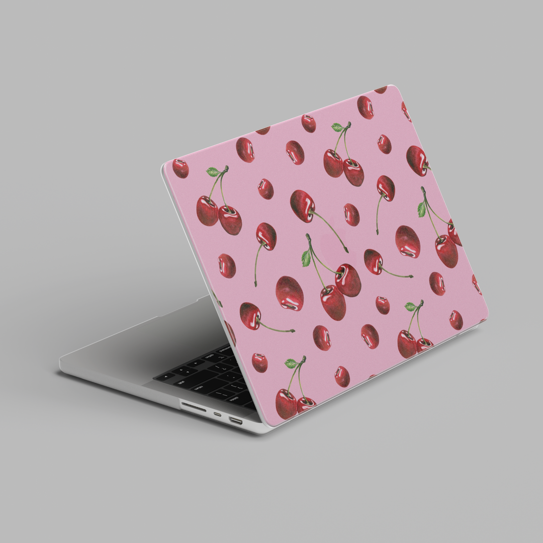 Pink MacBook case with scattered cherry pattern in a cute aesthetic design