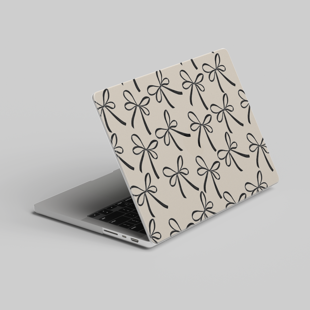 Beige MacBook case with black ribbon bow pattern, elegant minimal aesthetic laptop cover for MacBook Pro and MacBook Air models