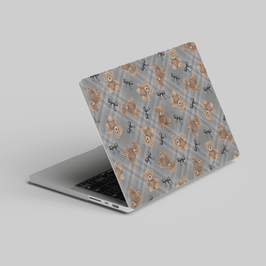Chic MacBook case featuring soft teddy bears and black bows over a grey plaid background, perfect for students, professionals, and creatives.