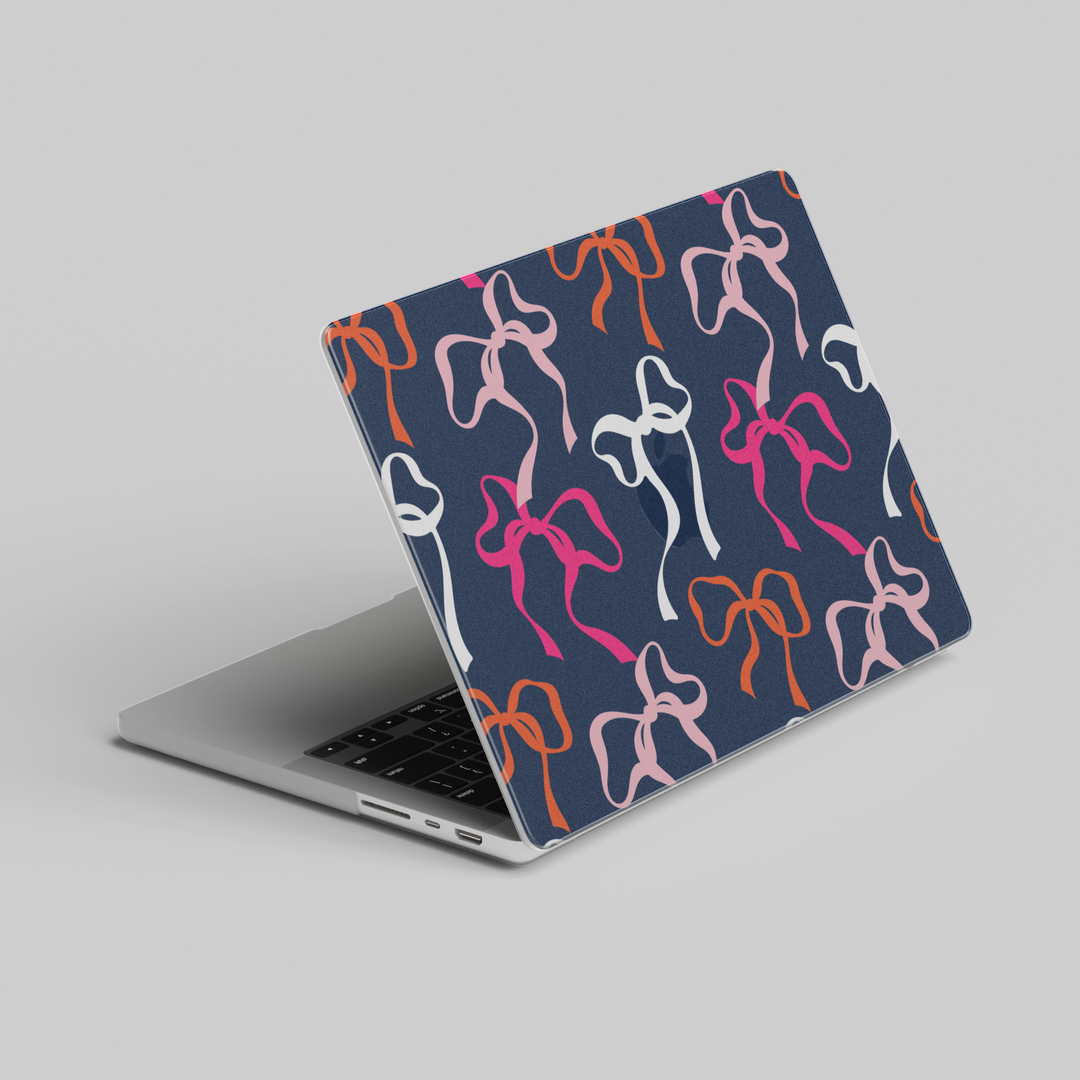 Navy blue MacBook case with bold colorful bows in pink, white, peach and orange – aesthetic girly tech cover for Air and Pro models