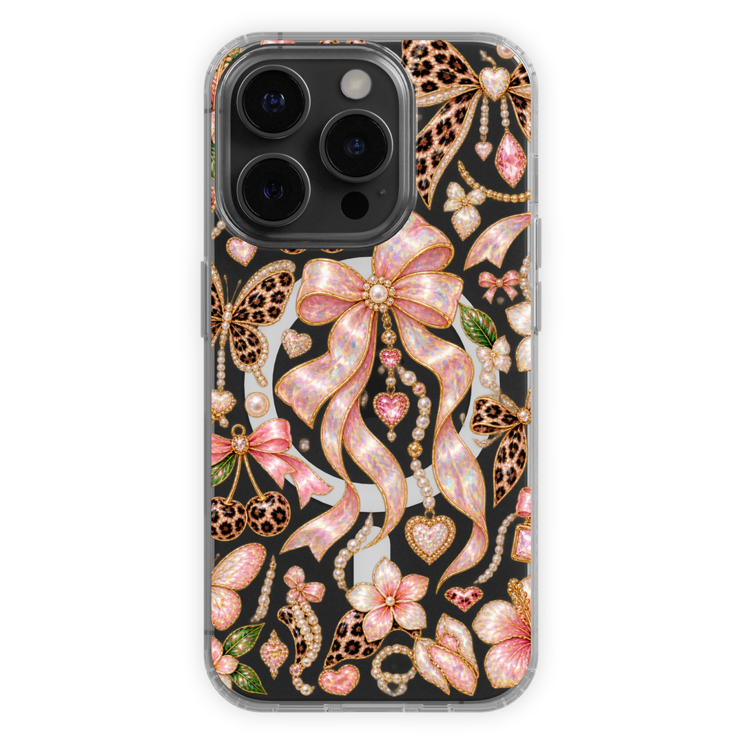 Clear MagSafe iPhone case with pink opal bows, leopard print butterflies, pearls, hearts and gold jewel-inspired details.