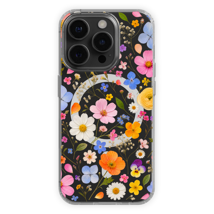 Clear MagSafe iPhone case with colorful pink, blue, orange, yellow and white wildflowers in a vibrant botanical pattern.