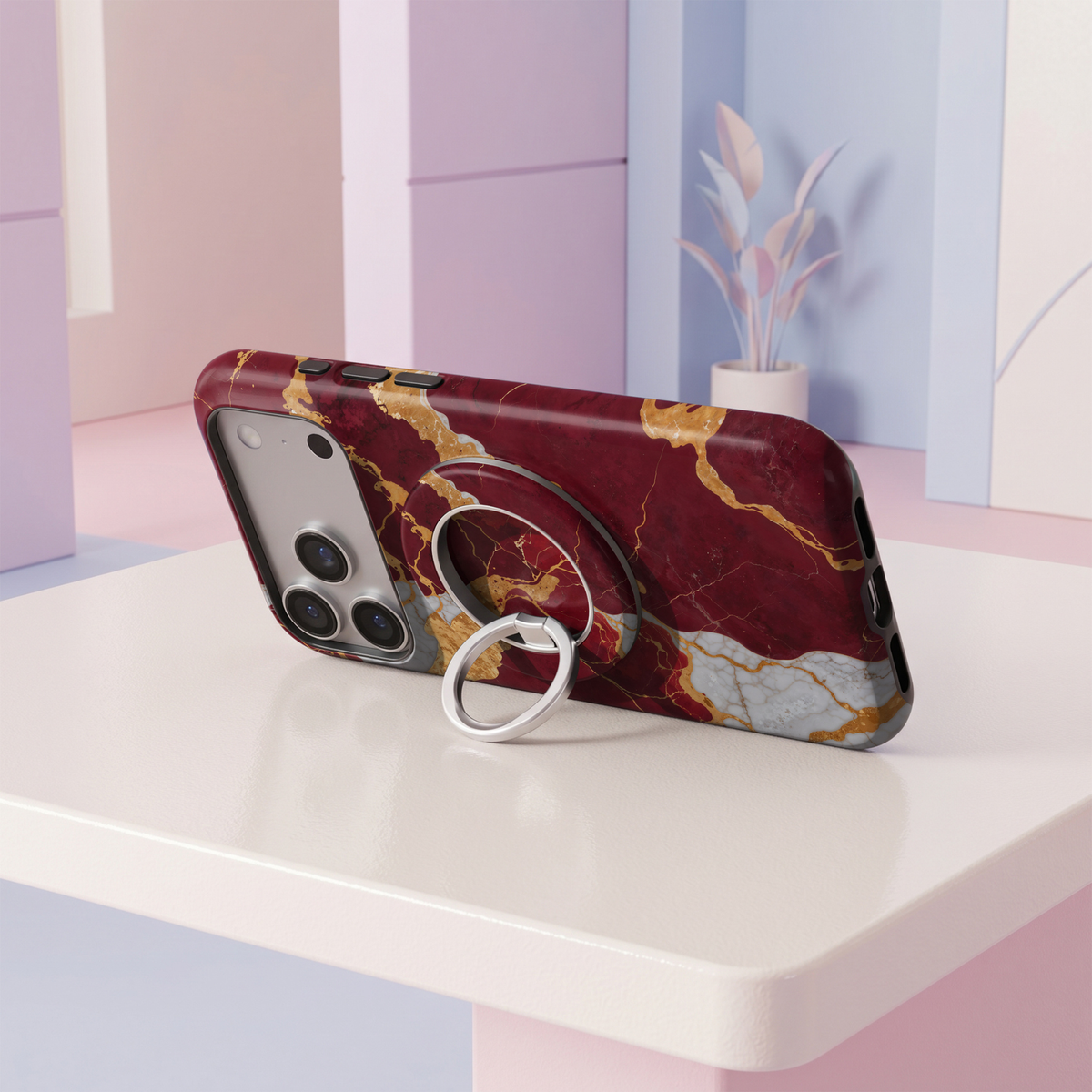 Burgundy Gold Marble MagSafe ring holder featuring a rich wine red marble design with bold metallic gold and white veining, finished with a sleek silver magnetic phone grip and stand.