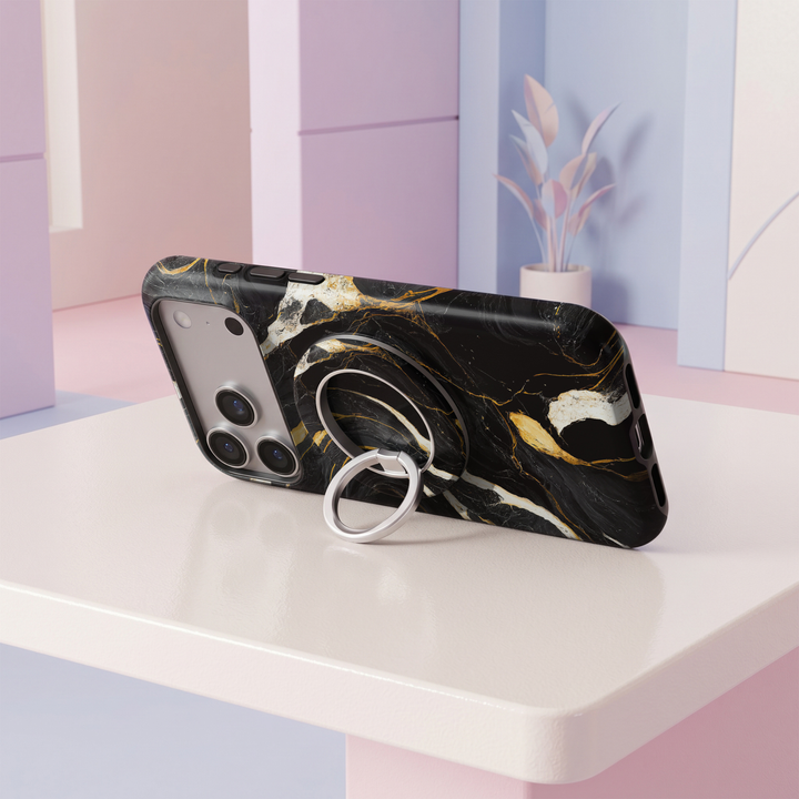 Midnight Gold Marble MagSafe ring holder featuring a luxurious black marble design with dramatic white veining and metallic gold accents, finished with a sleek silver magnetic phone grip and stand.