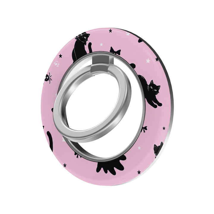 Pink Halloween MagSafe ring holder featuring playful black cats, tiny spiders, bows, stars, and a silver magnetic phone grip and stand.