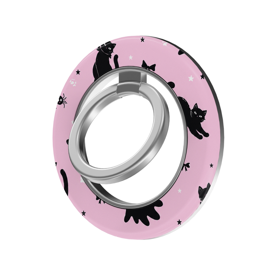 Pink Halloween MagSafe ring holder featuring playful black cats, tiny spiders, bows, stars, and a silver magnetic phone grip and stand.