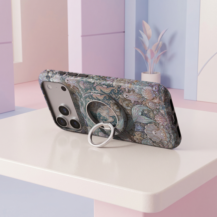 Mermaid Cove MagSafe ring holder featuring an iridescent ocean mosaic with seashells, pearls, seahorses and flowing aqua blue waves with a silver magnetic phone grip.