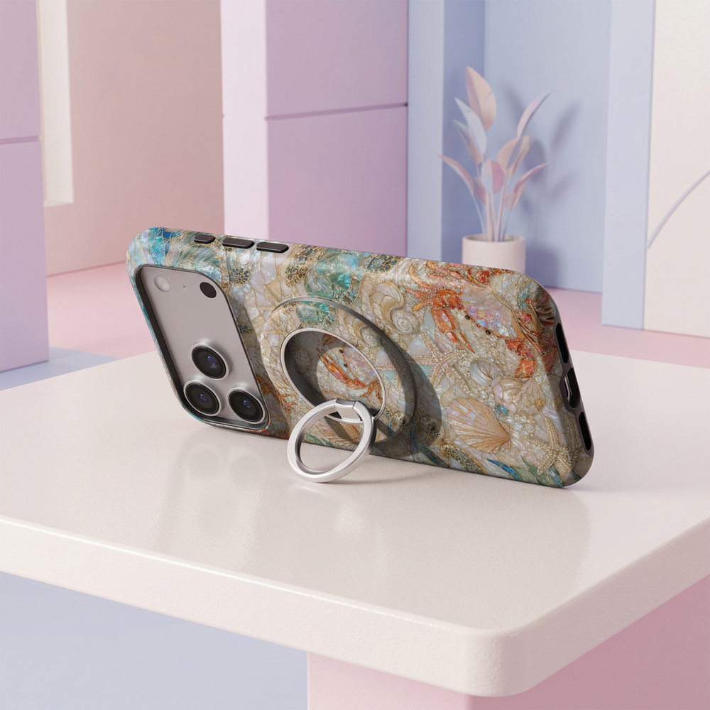 Coastal Treasures MagSafe ring holder featuring pearl seashells, starfish and turquoise sea turtles with elegant gold accents on an iridescent coastal background and silver magnetic phone grip.