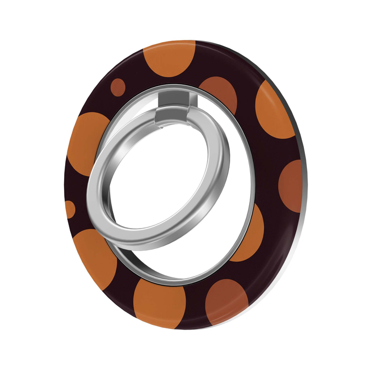CASELIX Amber Dots MagSafe Ring Holder featuring oversized burnt orange and caramel polka dots on a deep chocolate burgundy background, with a silver rotating metal finger ring for a chic, retro-inspired phone accessory.