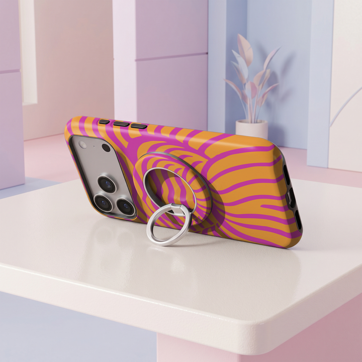 Bright pink and orange wavy abstract pattern MagSafe ring holder with a silver magnetic phone grip and stand.