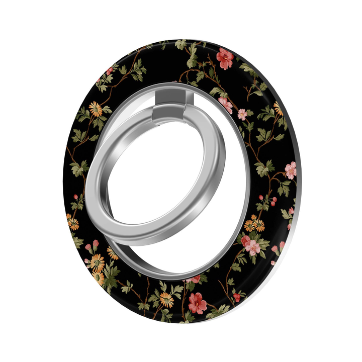 CASELIX Midnight Florals MagSafe Ring Holder featuring delicate pink and golden-yellow wildflowers with green leafy vines on a classic black background.