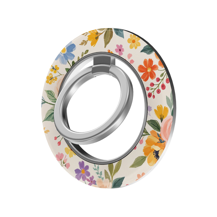 Meadow Bloom MagSafe ring holder featuring colorful wildflowers in orange, yellow, blue, pink and purple on a soft cream background with a silver magnetic phone grip.