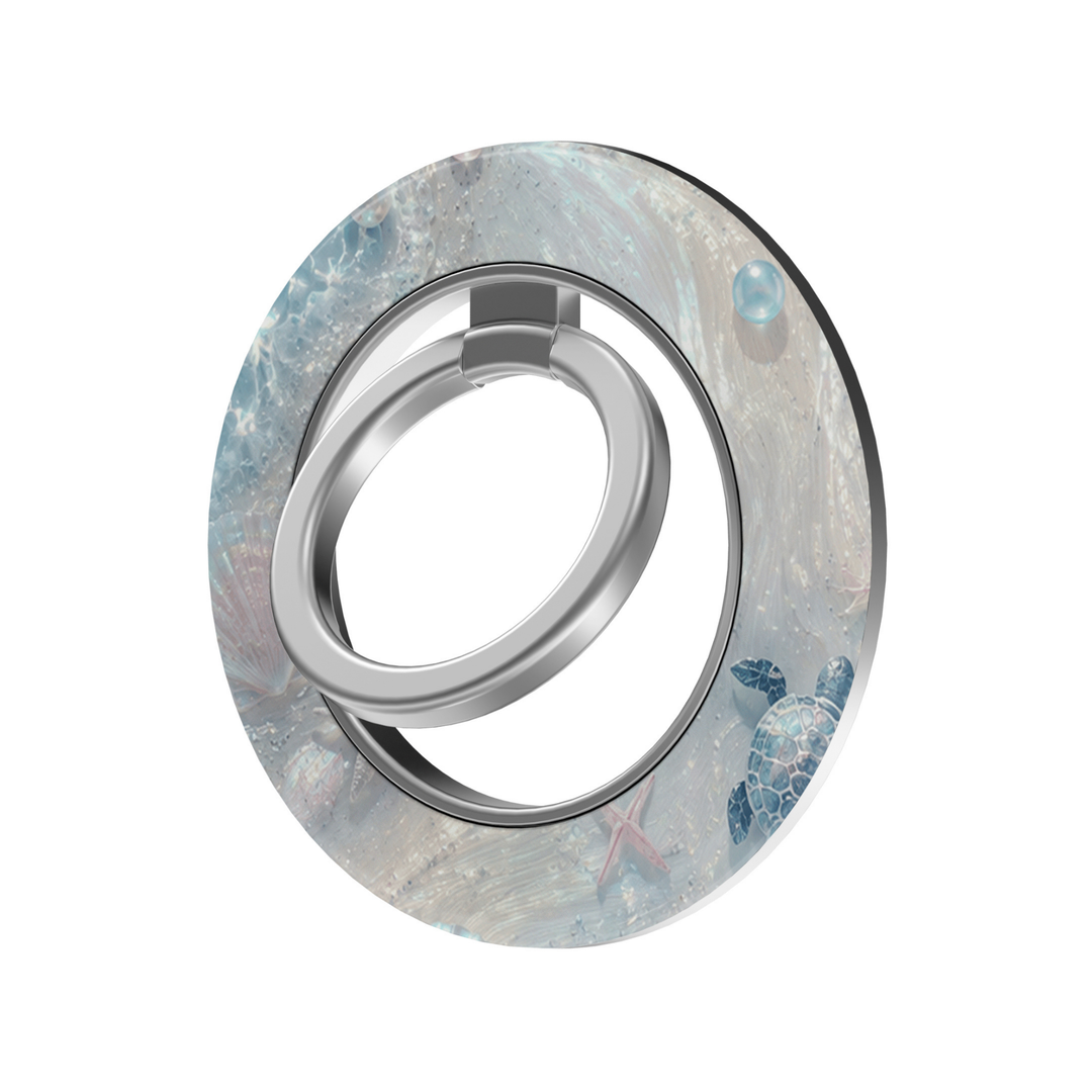 Pearl Lagoon MagSafe ring holder featuring an iridescent ocean design with seashells, pearls, starfish and blue sea turtles with a silver magnetic phone grip.