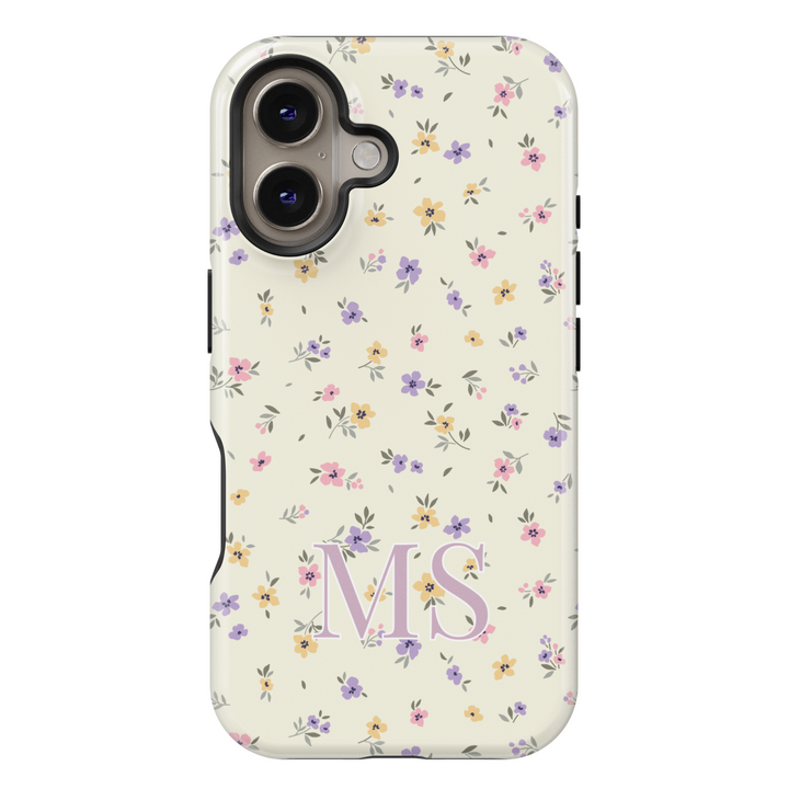 Personalized floral iPhone case with delicate pastel wildflowers and custom initials, creating a vintage, cottagecore-inspired aesthetic.