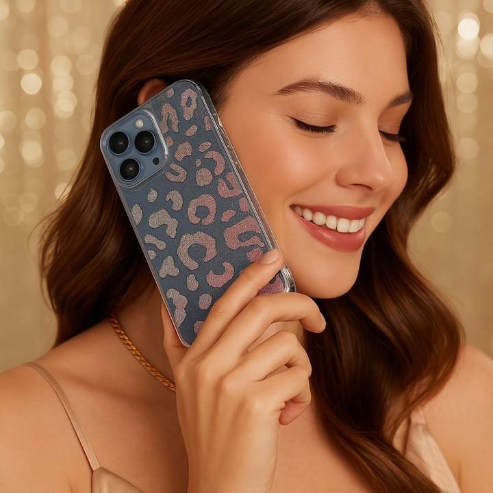 Stylish clear iPhone case featuring a holographic leopard print design with glitter details. The shimmering pattern reflects light beautifully, giving off a stunning iridescent effect. Perfect for those who love bold and trendy accessories while keeping their phone protected in style.
