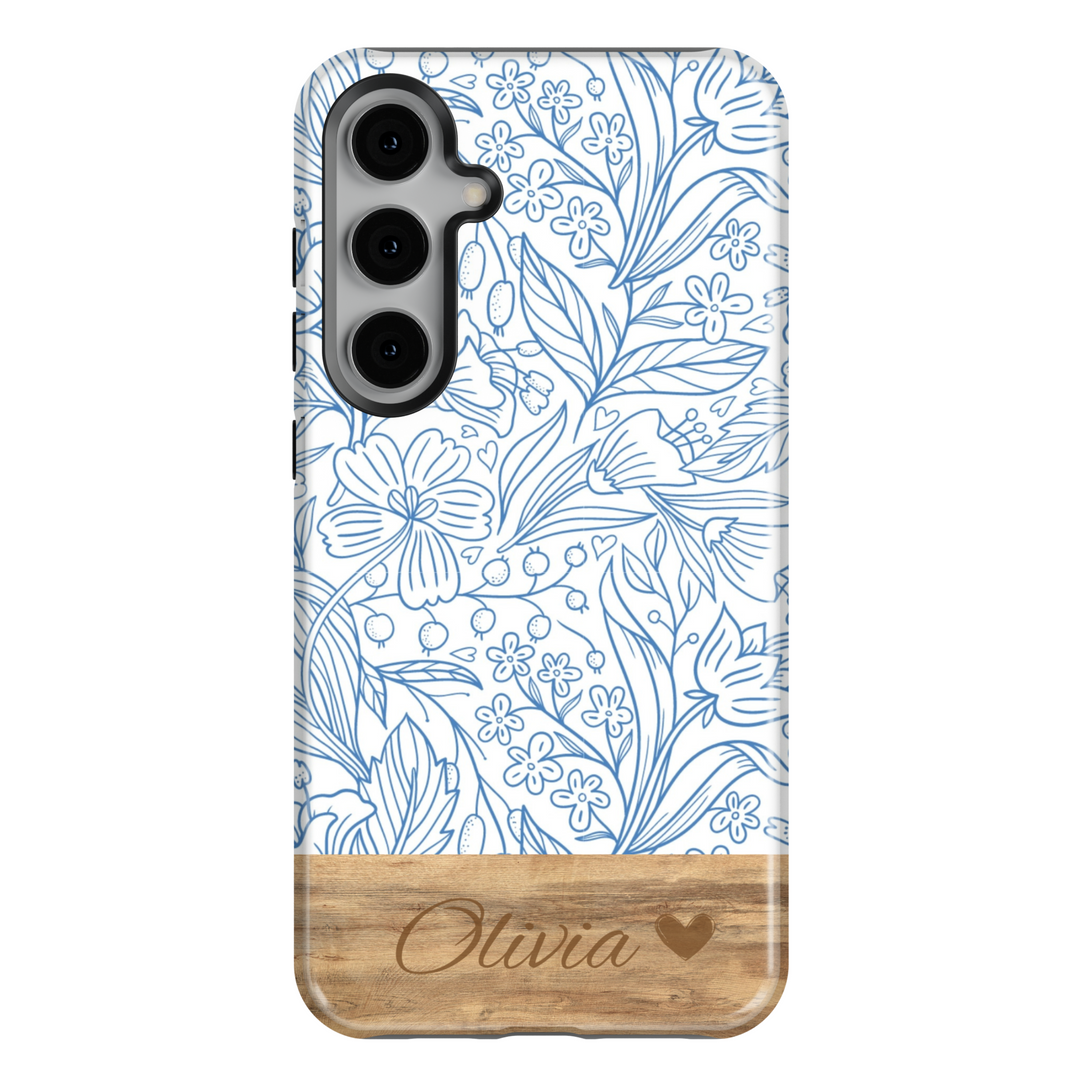 Elegant Samsung Galaxy phone case featuring a blue floral line art design with a woodgrain-textured bottom, personalized with a name engraving. Available for Samsung Galaxy S25 Ultra, S24 FE, S23, and more.