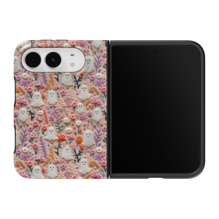 CASELIX Boo-tiful Blooms iPhone Duo Tough MagSafe folding phone case featuring adorable smiling white ghosts, pastel pink and lavender wildflowers, peach-orange blossoms, tiny white daisies, colorful botanical leaves, and a soft beige background. Cute girly Halloween phone case for women with a textured embroidery-inspired floral print, whimsical cottagecore aesthetic, pastel spooky season design, glossy printed finish, and protective two-piece foldable construction.