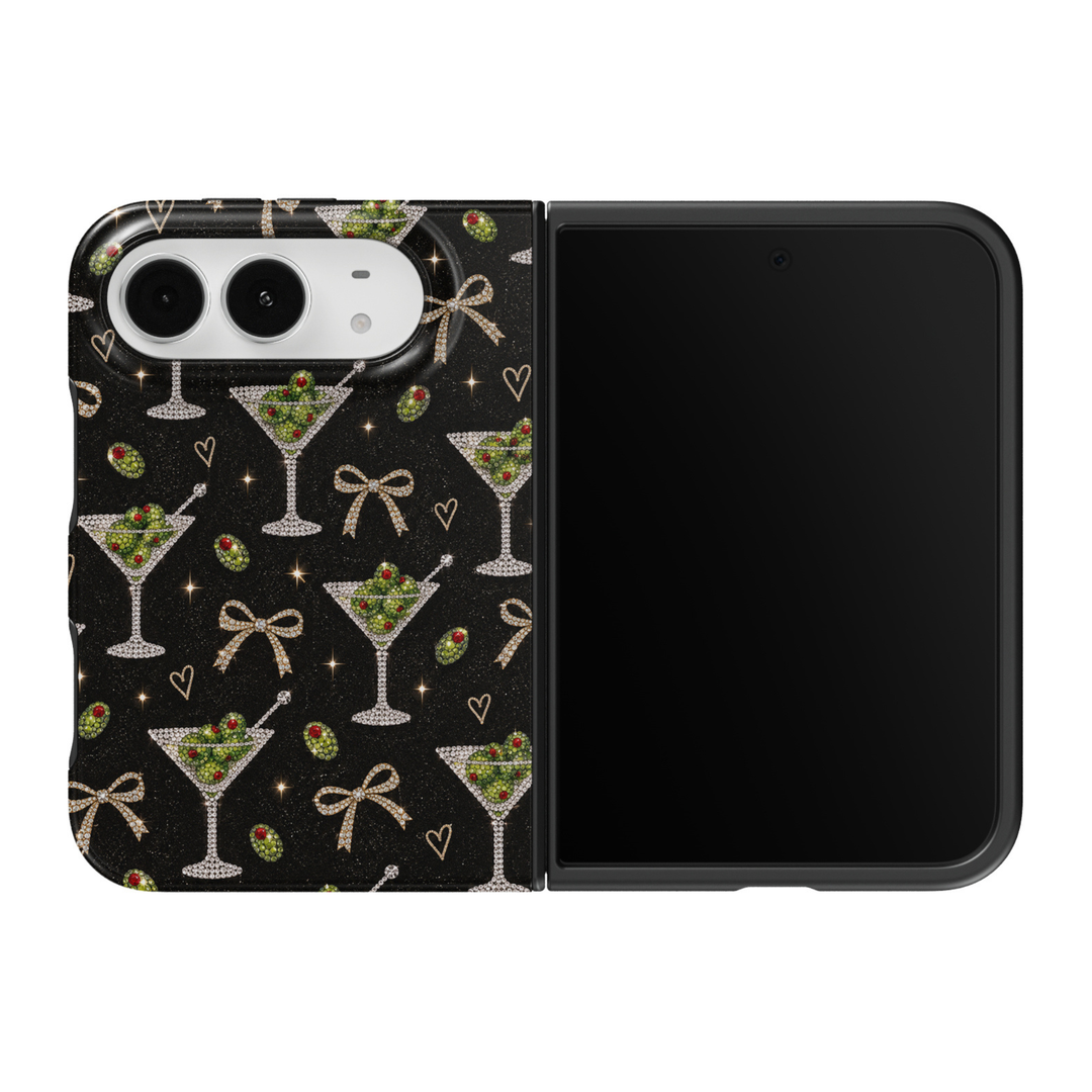 CASELIX Midnight Martini iPhone Duo Tough MagSafe folding phone case featuring a glamorous black background with repeating crystal-inspired dirty martini glasses, sparkling green olives with ruby-red pimentos, rhinestone-style champagne-gold bows, delicate gold hearts, and shimmering star accents. Luxury black martini phone case for women with a glossy printed finish, chic cocktail party aesthetic, glamorous girls&