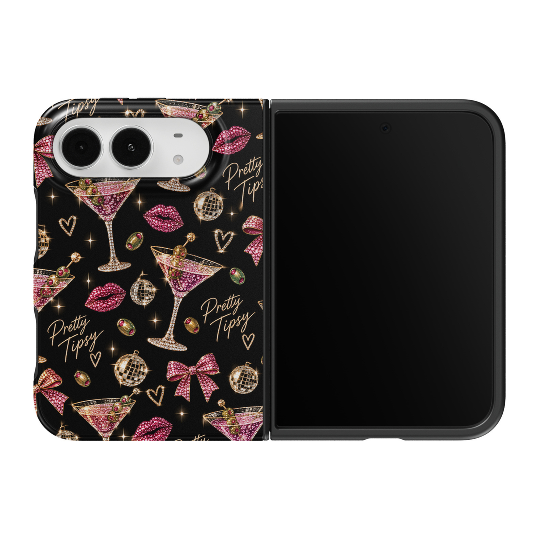 CASELIX Pretty Tipsy iPhone Duo Tough MagSafe folding phone case featuring a glamorous black background with sparkling pink rhinestone-style martini cocktail glasses garnished with green olives, fuchsia jeweled lipstick kisses, pink crystal-inspired ribbon bows, golden disco balls, glittering hearts, and elegant Pretty Tipsy gold script lettering. Trendy girls&
